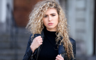 Curly haired woman black jacket - curly free wallpaper