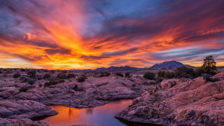 Sunset lake rocks trees mountain - a sunset over a lake free wallpaper