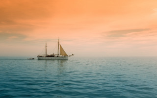 Sailboat ocean sunset yellow sky - australian tonalism free wallpaper