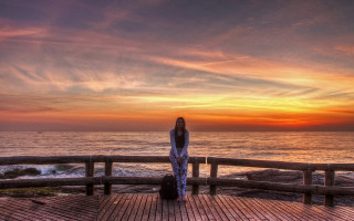 Woman arms legs deck ocean - sunrise free wallpaper