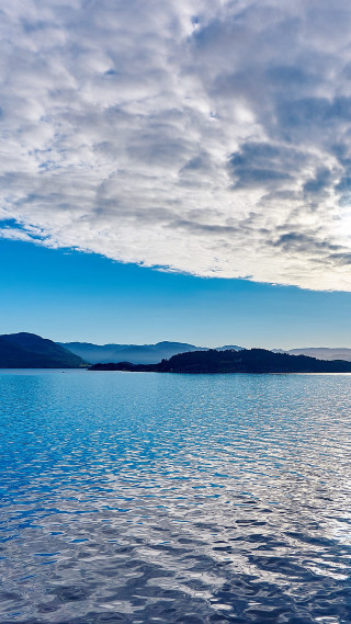 Boat water cloudy sky mountains 3 - the water under a cloudy sky free wallpaper for mobile