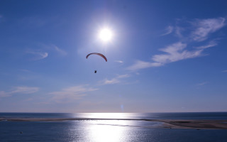 Parasailer ocean blue sky sunbeam - zenith view free wallpaper
