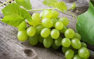 Grapes wooden table leafy plant - a bunch of grapes free wallpaper