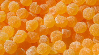 Orange candies sugar white background - a close up of a pile free wallpaper