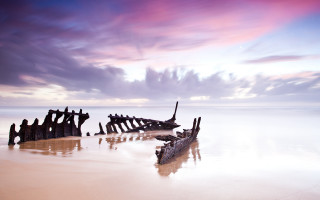 Beach wooden structures cloudy sky - the sand and water free wallpaper
