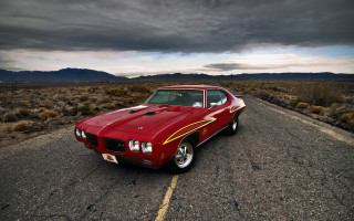 Red car desert mountains cloudy - daren bader free wallpaper