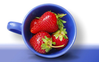 Blue bowl with strawberries on - a blue table free wallpaper