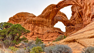 Large rock arch forest puzzle - a large rock formation free wallpaper