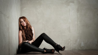 Woman sitting black leather pants - brown hair free wallpaper