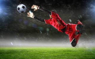 Soccer player red uniform kicking - his foot free wallpaper for desktop