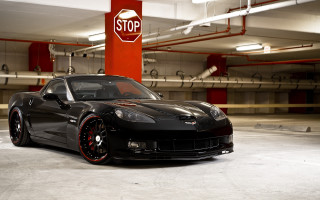 Black sports car stop sign - a parking garage next free wallpaper