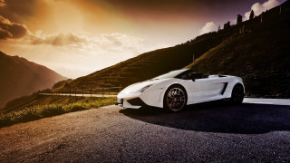 White sports car mountain sunset 2 - the side of a road near a mountain range free wallpaper