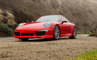 Red sports car mountain dirt - a foggy sky in the background free wallpaper