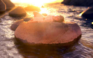 Woman rock water sunset flare - the sun shining behind her free wallpaper