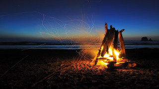 Beach campfire rock formation sunset - a campfire free wallpaper