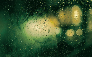 Rainy window streetlight building fireworks - green free wallpaper