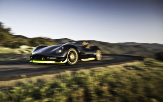 Black sports car green hillside 3 - a road next free wallpaper