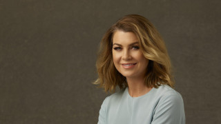 Blonde woman blue shirt smiling 2 - a gray wall behind her free wallpaper