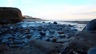 Bascove beach rocks water house - a house in the distance free wallpaper