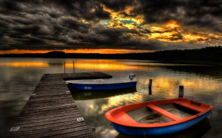 Docked boat lake sunset sky - dramatic free wallpaper for desktop