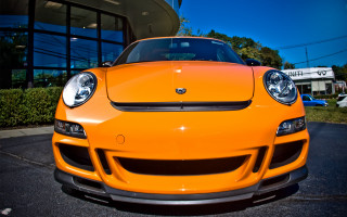 Yellow sports car building parkinglot - a parking lot in front free wallpaper