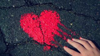 Hand touching red heart black - a hand free wallpaper