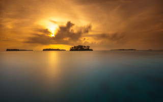 Sunset water island clouds mountains - a small island in the distance free wallpaper