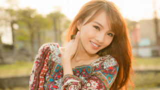 Red haired woman floral shirt - under her chin free wallpaper