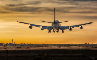 Large jetliner cloudy sunset runway - a plane in the air free wallpaper