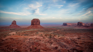 Desert rocks dirtroad clouds blue - a desert landscape free wallpaper