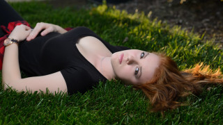 Woman laying on grass blurry 2 - a bunt free wallpaper