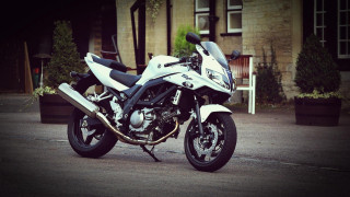 White motorcycle parked street building - plant free wallpaper