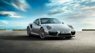 Silver porsche ocean cloudy sky - a road near the ocean free wallpaper