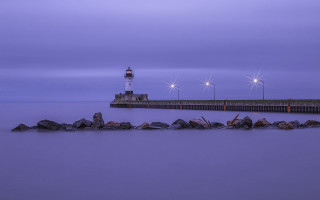 Lighthouse pier purple sky rocks - a purple sky in the background free wallpaper for desktop