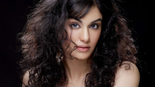 Woman long hair blue eyes 19 - a black background behind her free wallpaper