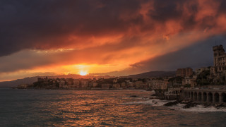 Sunset city water mountain skyline - a large body of water in front free wallpaper