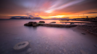 Sunset water rocks boat cloudy - derold page free wallpaper