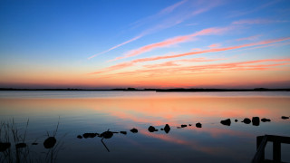 Sunset lake rocks dock clouds - a sunset over a lake free wallpaper