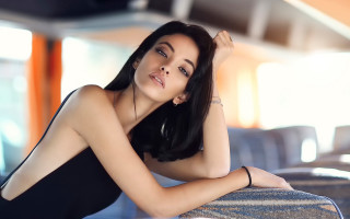 Woman black dress couch portrait - her arm free wallpaper for desktop