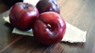 Three plums on cloth still - a cloth free wallpaper