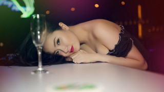 Woman black dress leaning table - a glass of wine in front free wallpaper