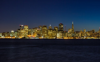 City skyline night water boat 7 - a boat in the foreground free wallpaper