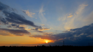 Sunset clouds cityscape horizon ocean - a few building free wallpaper