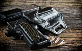 Gun belt wooden table lighter - a gun in the foreground free wallpaper