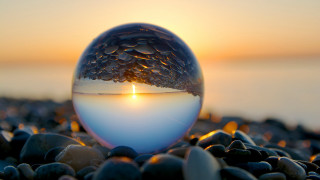 Candle glass ball rocky beach - a candle free wallpaper