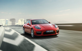 Red sports car city skyline 2 - a road in front free wallpaper