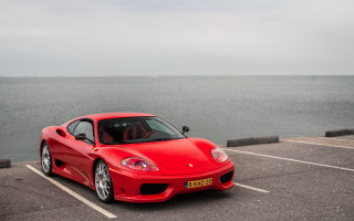 Red sports car ocean parking - a parking lot next free wallpaper