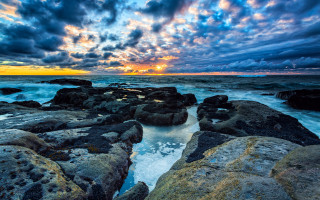 Sunset rocky beach waves clouds 3 - a sunset over a rocky beach free wallpaper