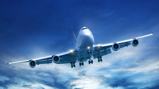 Large jetliner flying cloudy sky 3 - a cloudy blue sky free wallpaper
