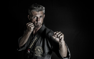 Man raising fists black shirt - figuration libre free wallpaper